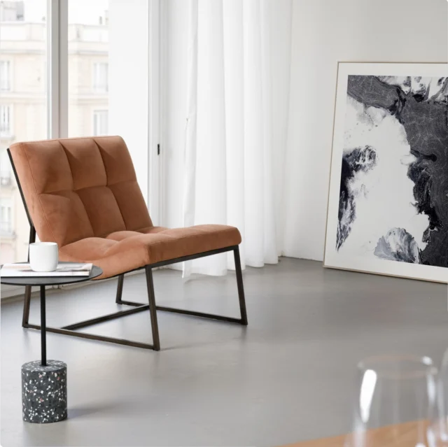 Thoughtfully hand-tufted for visual depth, the plush cognac velvet upholstery of the Moulin chair rests atop a sleek, angular dark bronze matt brushed stainless metal frame—delivering architectural poise with minimal effort.