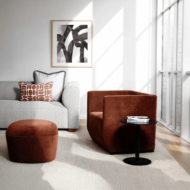 Wrapped in a rich, brick-toned chenille, the Rubin chair pairs crisp, cubed proportions with a subtle front slope and a sculptural cut-out backrest that enhances airiness and visual interest. Although geometric in form, its generous seat and considered angles guarantee comfort. The edgy look is layered with the bold-patterned Coral Pop lumbar cushion, which echoes the brick palette, and is softened by the plush texture of the Cappuccino Mohair cushion, which is finished with a thick textured piped edge.
