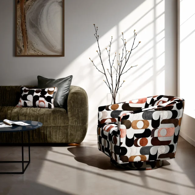 Defined by its signature gathered ruffle and horizontally stitched lines, the Revvy sofa delivers contemporary splendour in a radiant olive velour fabric. Complemented by the Artemis swivel in Vintage Abstract.